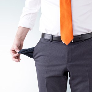 Person in business attire showing empty pocket, symbolizing bankruptcy