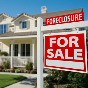 Foreclosure signs prominently displayed in front of a house - Nager Law Group